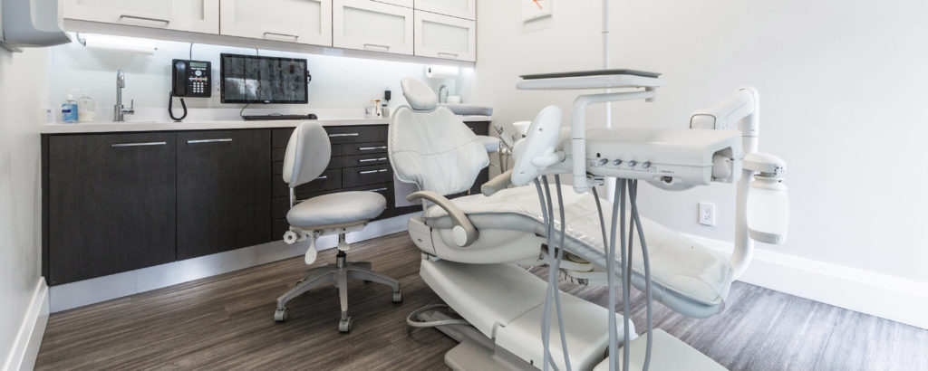 Dental office with a dental chair, equipment, and cabinets at VP Dental