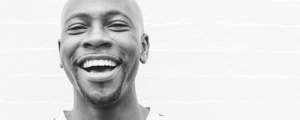 Smiling man showing healthy teeth, highlighting successful endodontic treatment